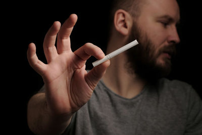 Hands bearded man with cigarette, close up. give up smoking cigarettes. 