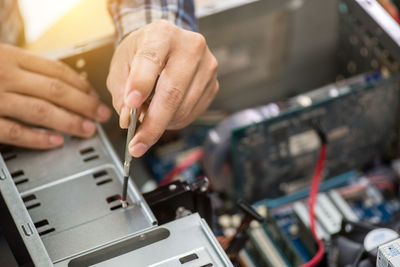 Cropped hands of technician repairing computer equipment