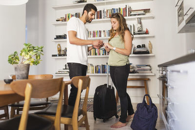 Couple discussing while going for vacation at home