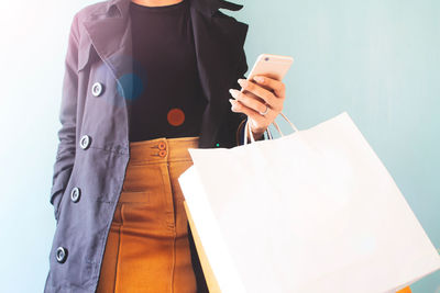 Midsection of man using mobile phone