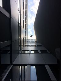 Directly below shot of modern glass building against sky