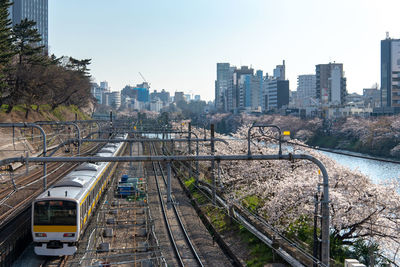 High angle view of railroad tracks amidst buildings in city