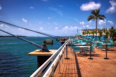 View of swimming pool by sea against sky