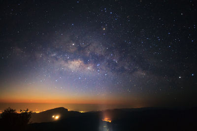 Scenic view of silhouette mountain against sky at night