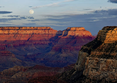 Scenic view of rock formations against cloudy sky