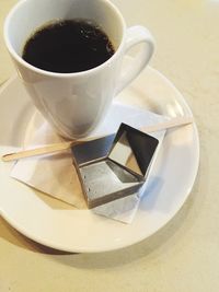 High angle view of coffee cup on table