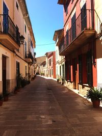 Empty alley amidst buildings in city