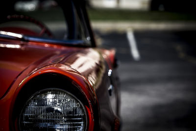 Close-up of red car on road