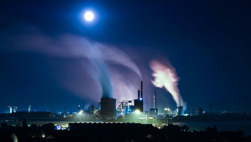 Smoking emanating from chimneys of industry at night