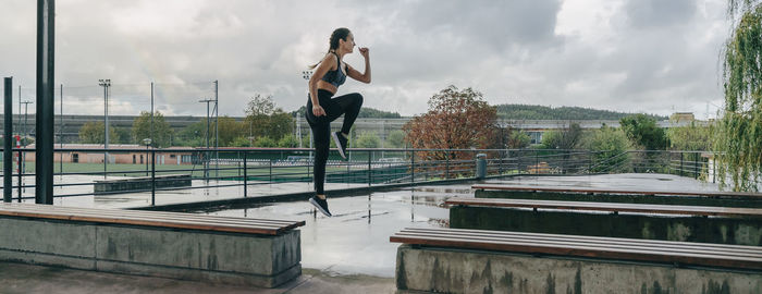 Full length of woman on railing against sky