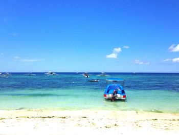 Scenic view of sea against blue sky