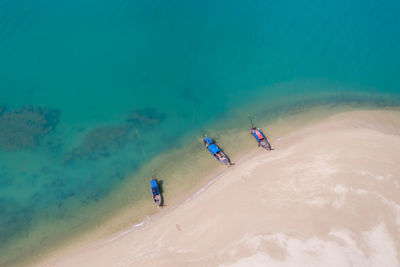 Long tail boat on the sand beach in island kra bi thailand aerial view