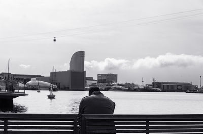 Rear view of man on bridge over river