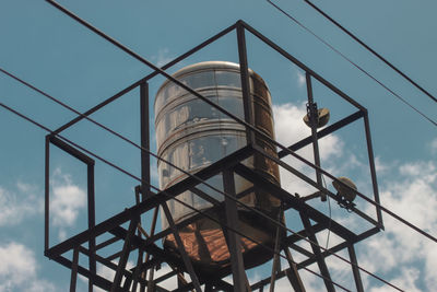 Water tower with blue and white sky background