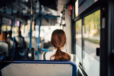 Rear view of woman traveling in bus