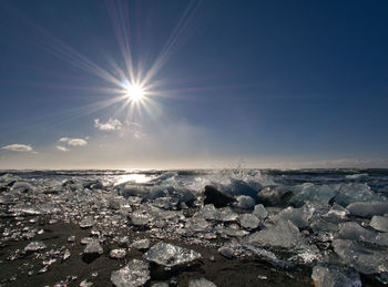 Scenic view of sea against sky on sunny day