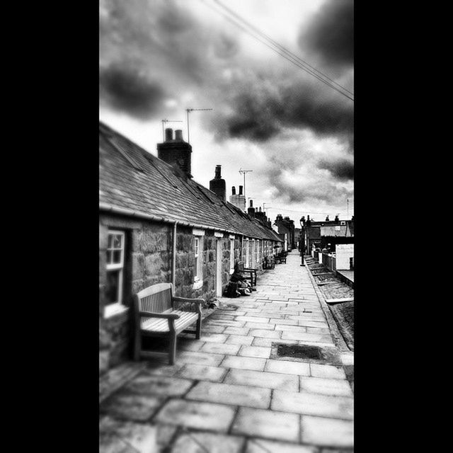 architecture, built structure, building exterior, sky, the way forward, cloud - sky, cloudy, cloud, building, residential structure, house, street, city, diminishing perspective, residential building, cobblestone, outdoors, walkway, incidental people, day