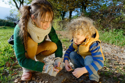 Mid adult woman with son playing on field