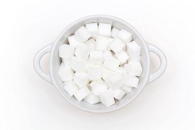 High angle view of ice cream in plate against white background