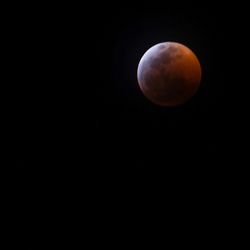 Low angle view of moon against sky at night