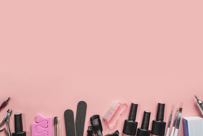 High angle view of personal accessories against pink background