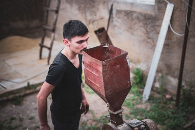 A man makes animal feed at home.