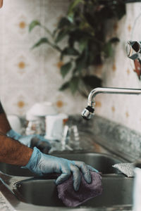 Low section of man washing hands