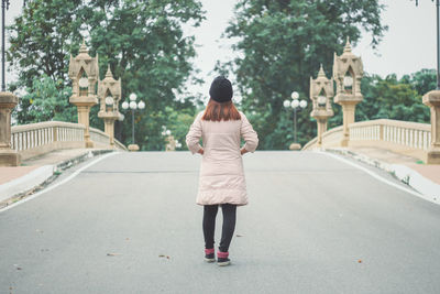 Rear view of woman walking on street in city