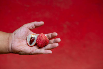 Close-up of hand holding strawberry