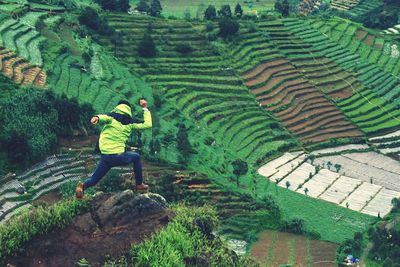 High angle view of person jumping on hill