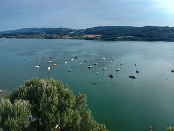 High angle view of boats in sea against sky