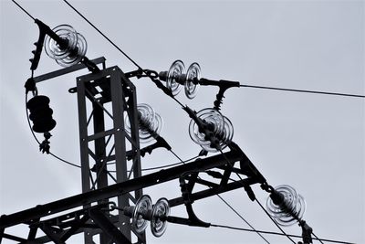 Low angle view of electricity pylon against sky