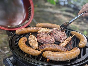 Close-up of person hand on barbecue grill