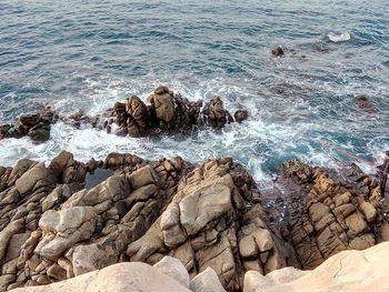 Waves splashing on rocks at shore