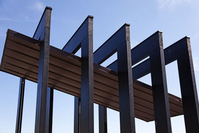 Low angle view of modern building against blue sky