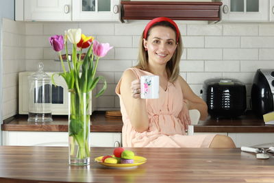 Portrait of a smiling young woman at home