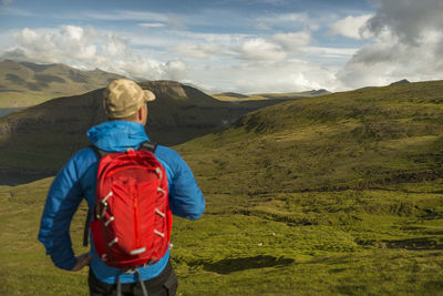 Rear view of man standing on mountain