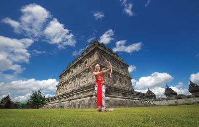 Low angle view of woman in traditional clothing holding 