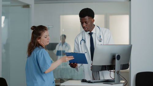 Female doctor examining patient in hospital