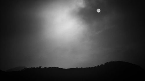 Low angle view of silhouette trees against sky at night