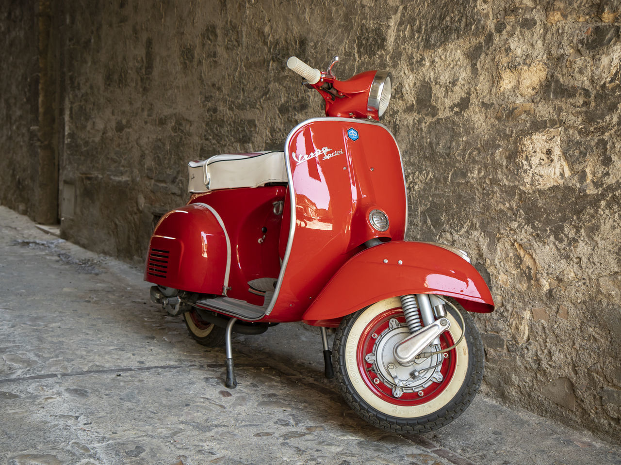 RED TOY MOTOR SCOOTER ON WALL