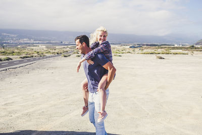 Man carrying woman piggyback