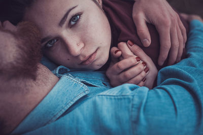 High angle view of couple lying on grass outdoors