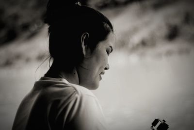 Close-up of young woman sitting outdoors