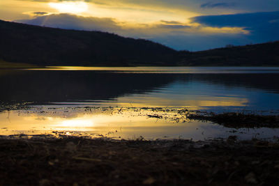 Scenic view of lake against sky during sunset