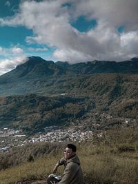 Man on mountain against sky