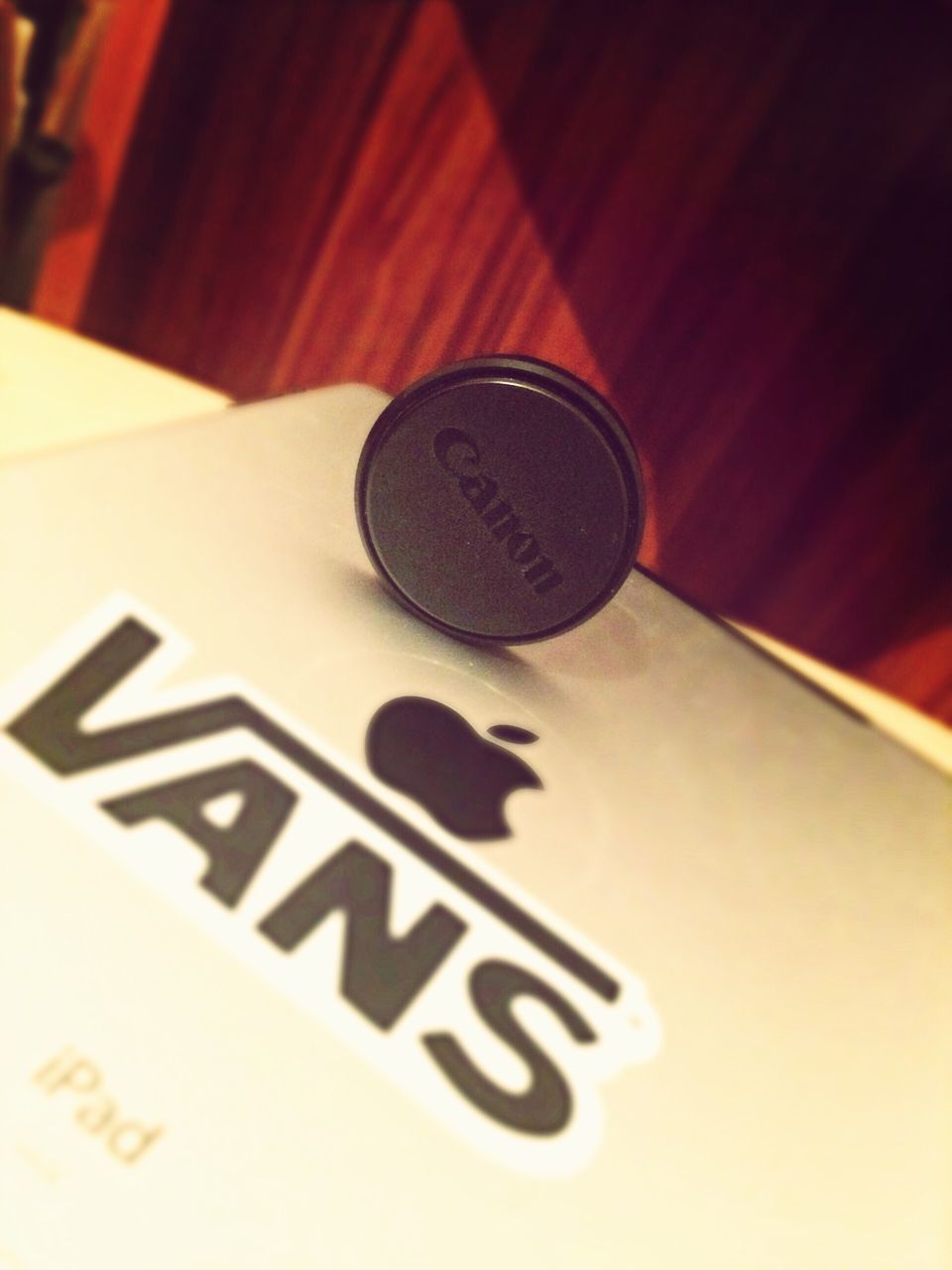 indoors, table, still life, close-up, communication, technology, wood - material, no people, high angle view, text, selective focus, coffee cup, western script, home interior, focus on foreground, drink, food and drink, wireless technology, single object, music