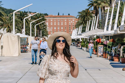 Portrait of young woman walking on riva promenade in city of split in croatia