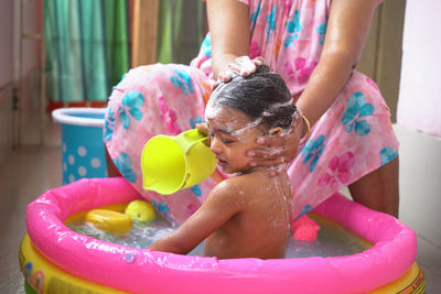 Midsection of boy playing in water