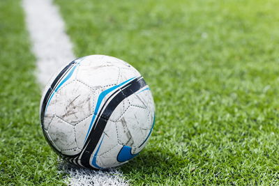 Close-up of soccer ball on field